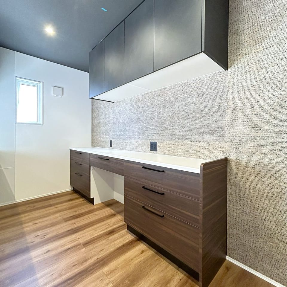 カップボードは収納に困らないワイドタイプが嬉しい。ストーン調のアクセントクロスがワンポイントに。