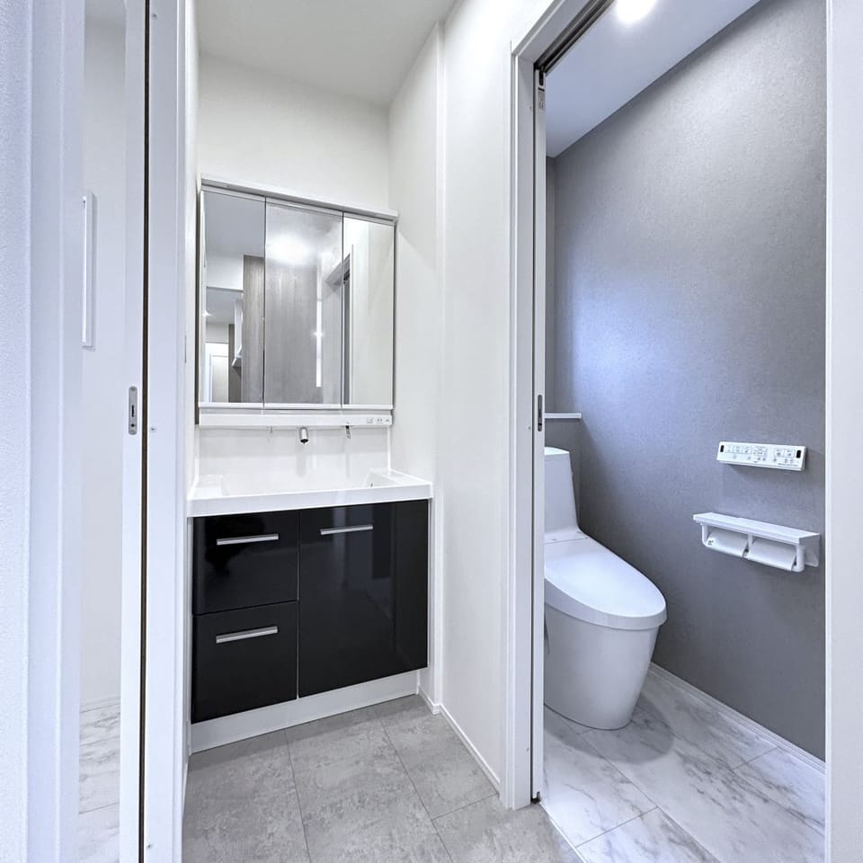 洗面化粧台もグレーでまとめ、家全体と統一感を。脱衣室から独立させ、ご家族全員がいつでも使いやすく。