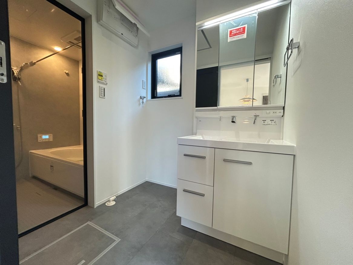 洗面脱衣所 三面鏡付きの洗面台 鏡の内部にはコンセントもついている収納となっています